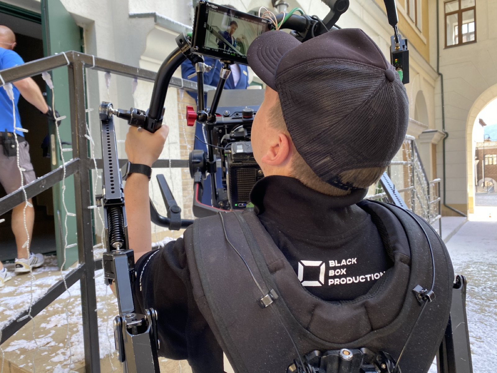 Camera operator filming from behind