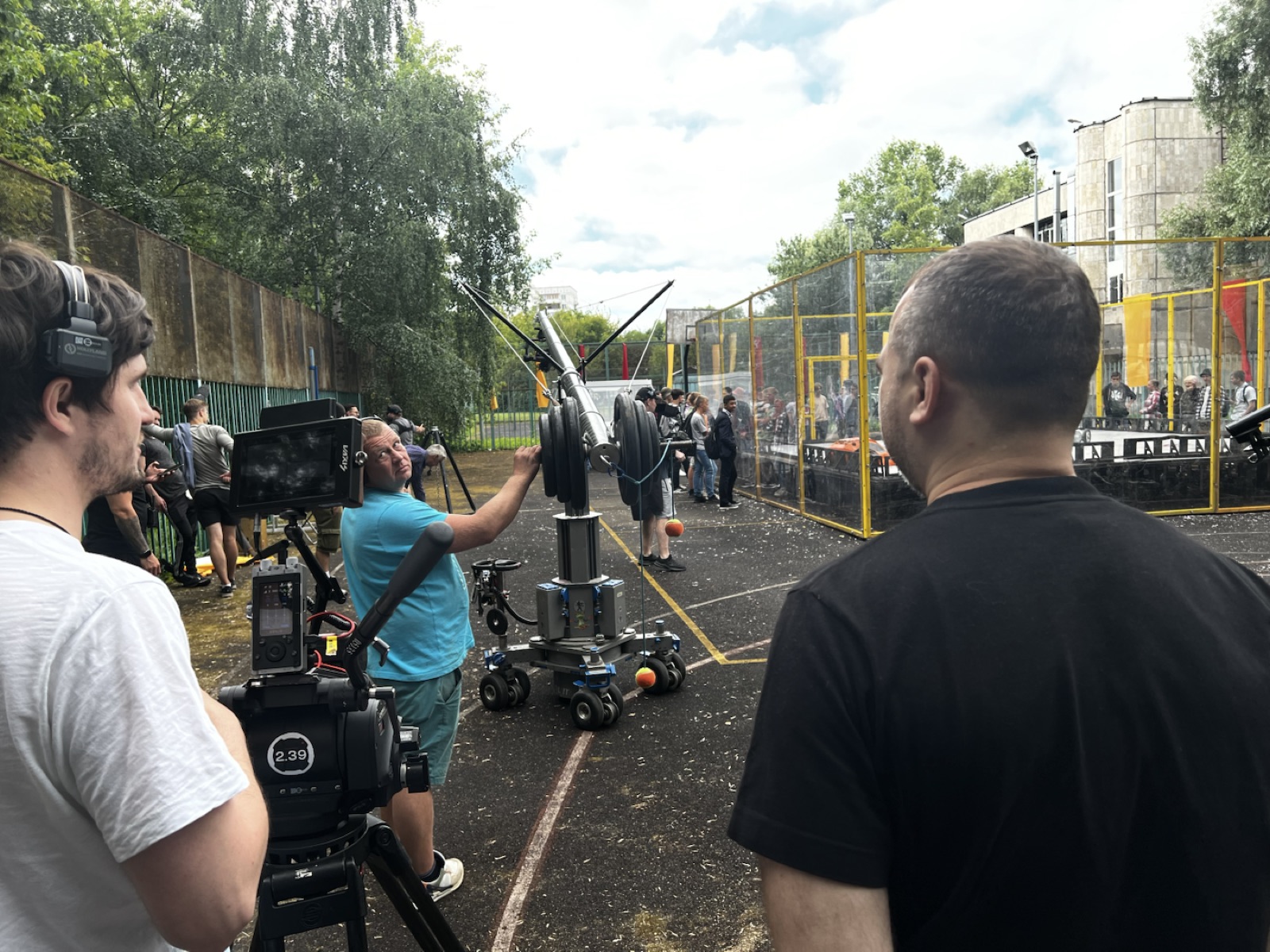 Production crew seen from behind on an outdoor set